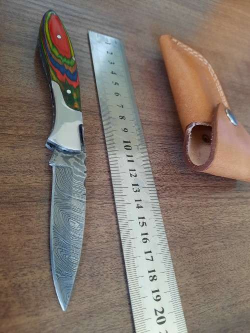 Handmade Damascus steel folding knife with Wooden handle scales.