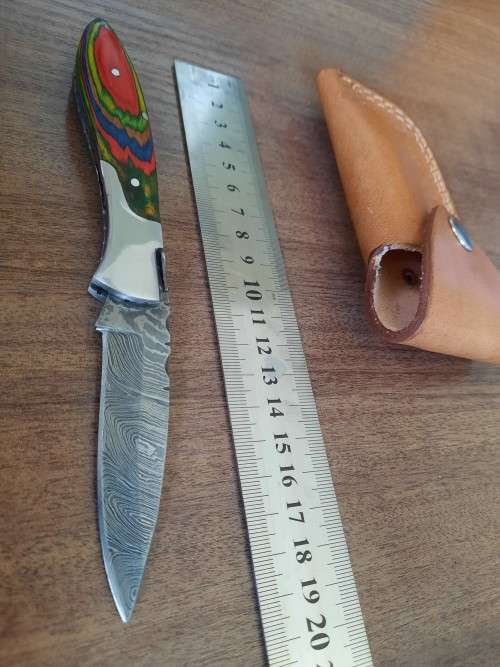 Handmade Damascus steel folding knife with Wooden handle scales.