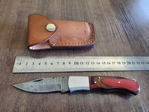Handmade Damascus steel folding knife with Wooden handle scales.