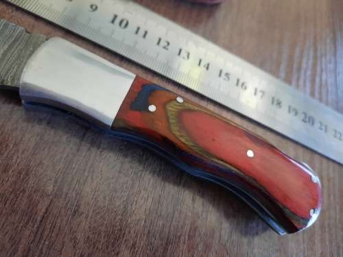 Handmade Damascus steel folding knife with Wooden handle scales.