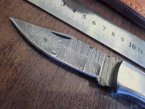 Handmade Damascus steel folding knife with Wooden handle scales.