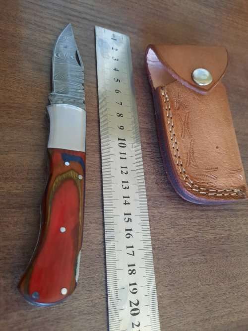 Handmade Damascus steel folding knife with Wooden handle scales.