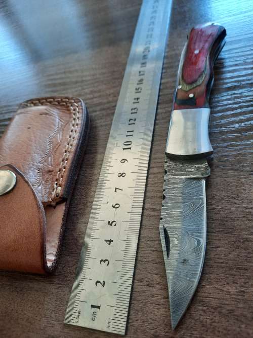 Handmade Damascus steel folding knife with Wooden handle scales.
