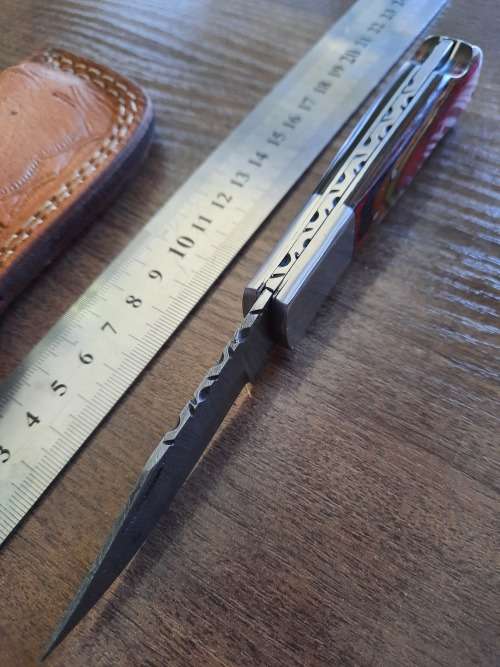 Handmade Damascus steel folding knife with Wooden handle scales.