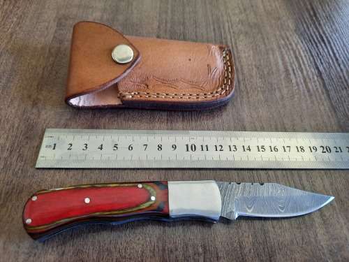 Handmade Damascus steel folding knife with Wooden handle scales.