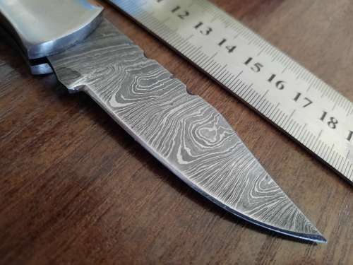 Handmade Damascus steel folding knife with Wooden handle scales.