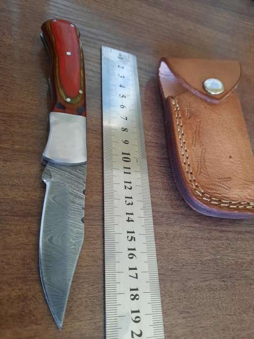 Handmade Damascus steel folding knife with Wooden handle scales.
