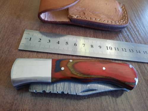 Handmade Damascus steel folding knife with Wooden handle scales.