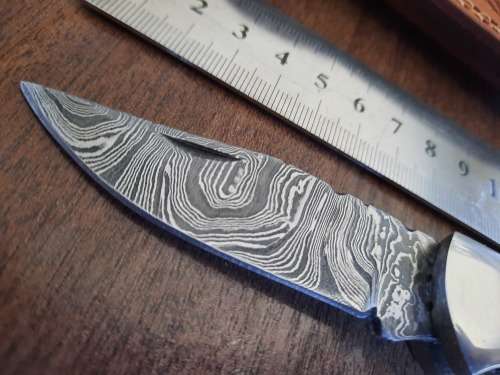 Handmade Damascus steel folding knife with MICARTA handle scales.