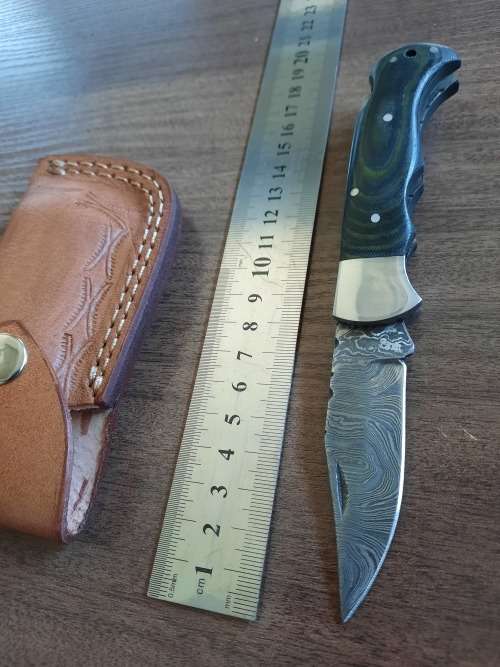 Handmade Damascus steel folding knife with MICARTA handle scales.