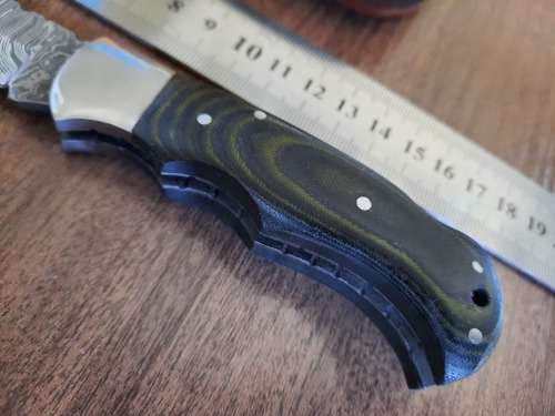 Handmade Damascus steel folding knife with MICARTA handle scales.