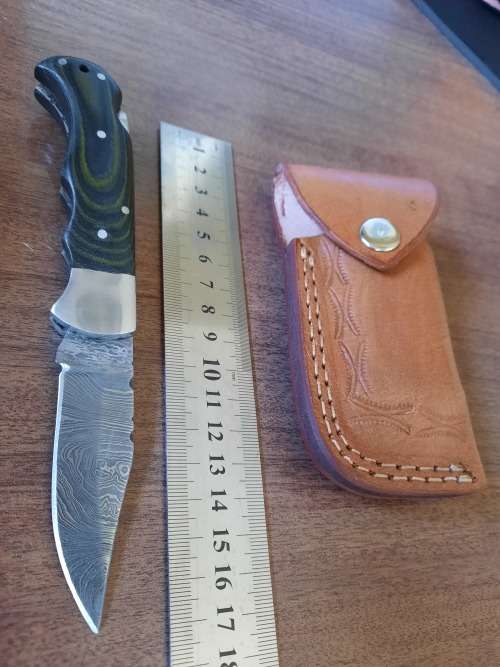 Handmade Damascus steel folding knife with MICARTA handle scales.