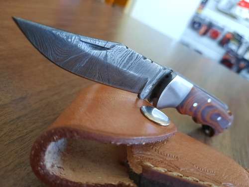 Handmade Damascus steel folding knife with MICARTA handle scales.