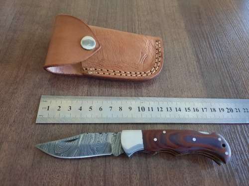 Handmade Damascus steel folding knife with MICARTA handle scales.