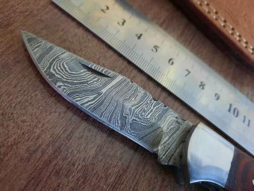 Handmade Damascus steel folding knife with MICARTA handle scales.