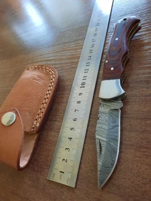 Handmade Damascus steel folding knife with MICARTA handle scales.