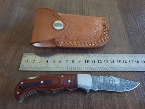 Handmade Damascus steel folding knife with MICARTA handle scales.