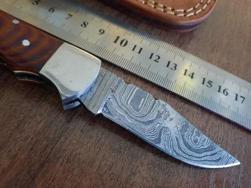 Handmade Damascus steel folding knife with MICARTA handle scales.