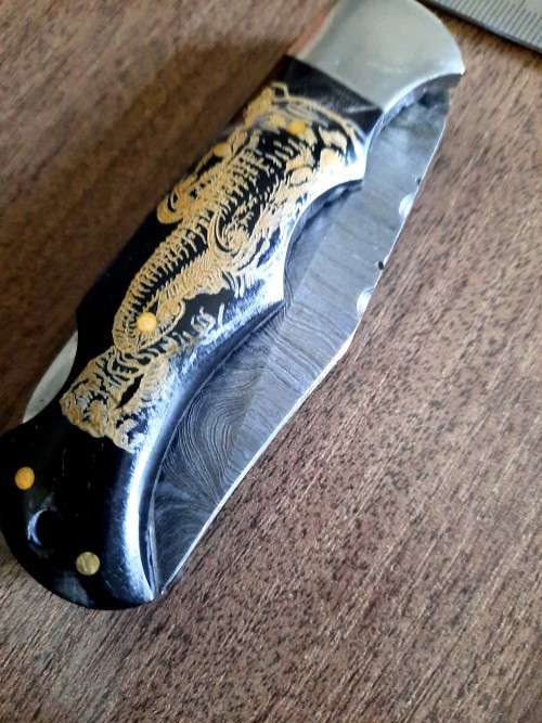 Handmade Damascus steel folding knife with Bull Horn Handle. Elephant picture engraved. NEW STOCK !