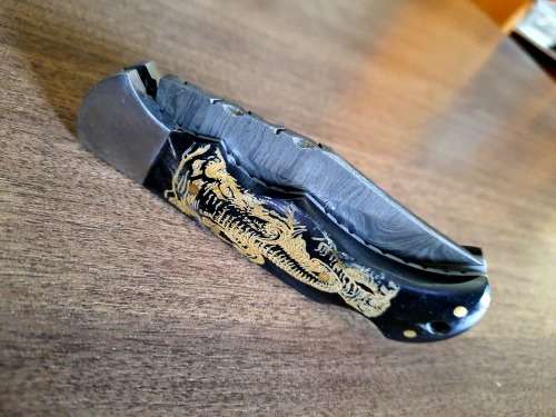 Handmade Damascus steel folding knife with Bull Horn Handle. Elephant picture engraved. NEW STOCK !