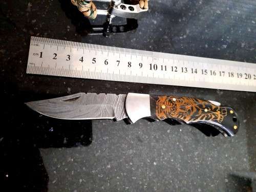 Handmade Damascus steel folding knife with Bull Horn handle scales. FREE Bracelet