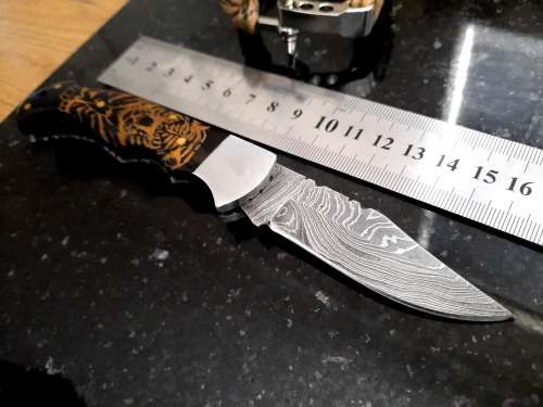 Handmade Damascus steel folding knife with Bull Horn handle scales. FREE Bracelet