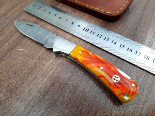 Handmade Damascus steel folding knife with Epoxy Resin handle scales. Crazy R1 start, no reserve.