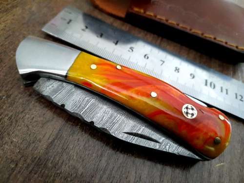 Handmade Damascus steel folding knife with Epoxy Resin handle scales. Crazy R1 start, no reserve.