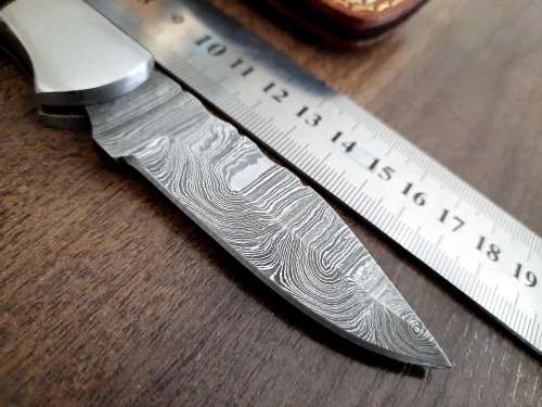 Handmade Damascus steel folding knife with Epoxy Resin handle scales. Leather pouch included.