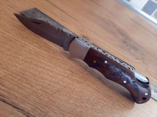 Handmade Damascus steel folding knife w Wooden Handle Scales. Pouch in bad shape, see pictures.