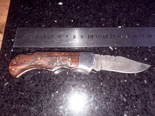 Handmade Damascus steel folding knife w Wooden Handle Scales. Pouch in bad shape, see pictures.