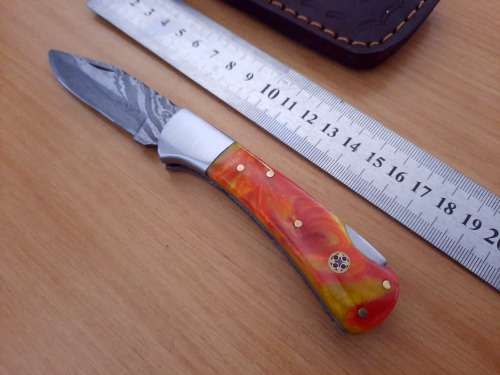 Handmade Damascus steel folding knife w Epoxy Resin Handle Scales. Exact knife you will receive.
