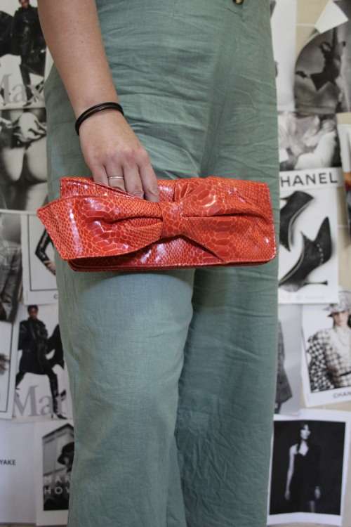 Orange Nine West Clutch with Faux Snakeskin and Bow Detail (Measures 12 x 26 cm)