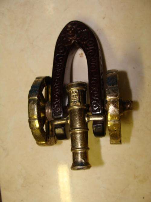 SMALL ORNAMENTAL METAL CANNON WITH WOODEN BACK AND WHEELS & CANNON IN METAL