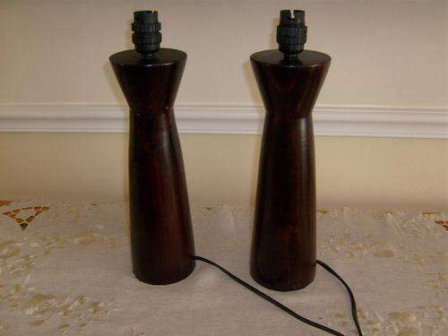 A PAIR OF WOODEN DARK STAINED TABLE LAMPS (BID IS FOR BOTH)