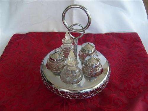 ANTIQUE BEAUTIFUL 5 PIECE CUT GLASS AND CHROME CRUET SET ON A EMBOSSED REVOLVING SERVING TRAY