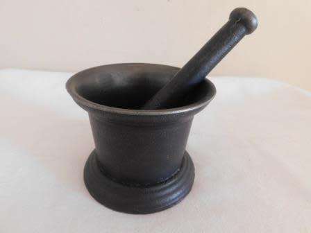 A KENRICK & SONS CAST IRON MORTAR AND PESTLE