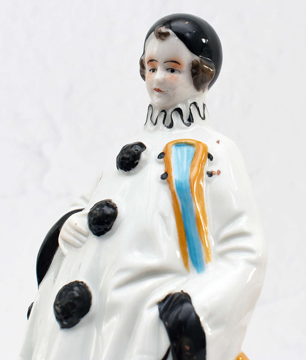 30s romantic Pierrot figurine holding a mandolin