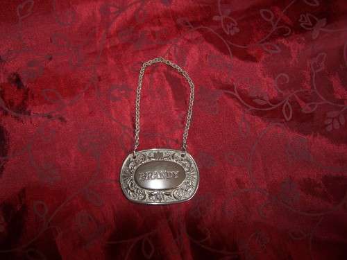 Silver plated brandy label on chain