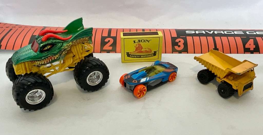Assorted three toy cars, including a Monster Jam model