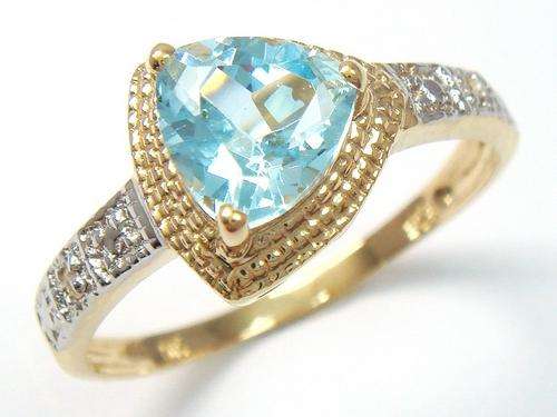 Beautiful solid 9kt gold and genuine blue topaz and diamond ring.