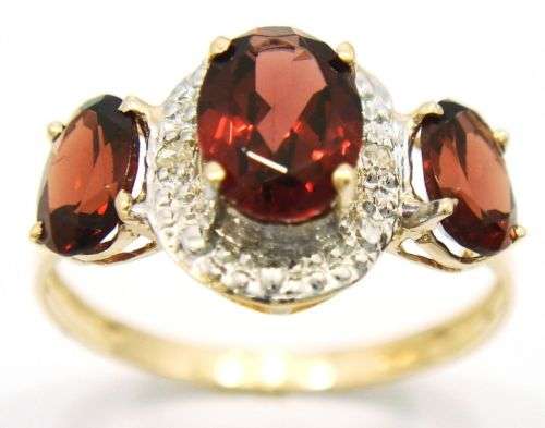 Beautiful solid 9kt gold and genuine garnets and diamond ring.