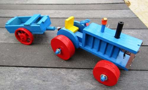 HAND MADE LARGE WOODEN FARM TRACTOR IN BLUE WITH TRAILER. WOODEN WHEELS. NOT DINKY.
