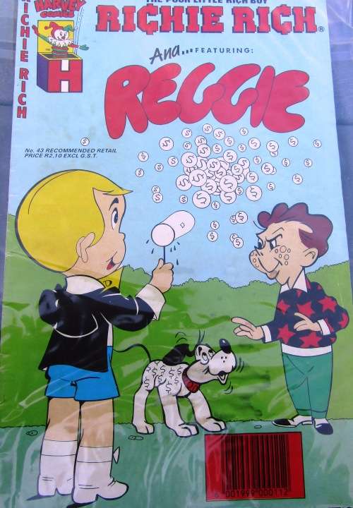 SCARCE COMIC `RICHIE RICH AND REGGIE` IN SEALED PLASTIC COVER.