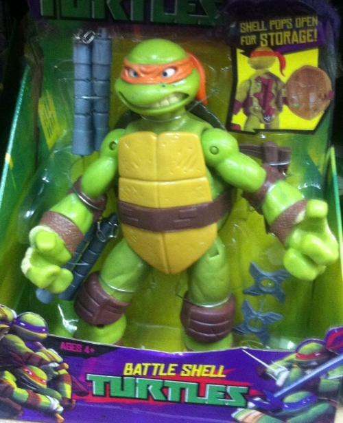 reduced Ninja turtles moveable plastic figurine 27cm - with weapons - shell pops open - orange