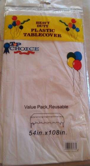 White plastic table cover- 54in by 108in