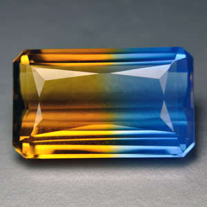 15.35 ct GOLD  & BLUE EMERALD CUT QUARTZ GEMSTONE