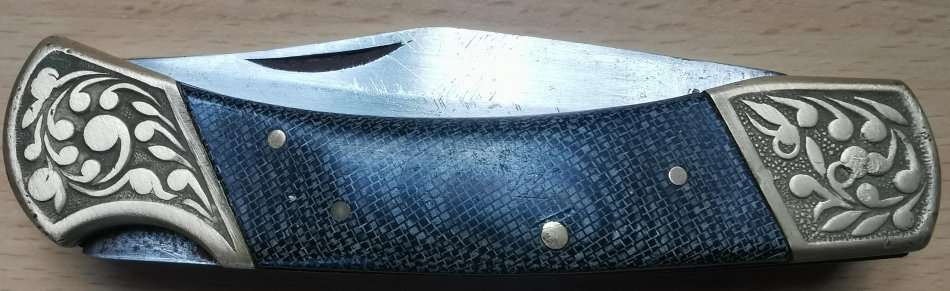 Large vintage stainless steel lock knife with snakeskin pattern handle