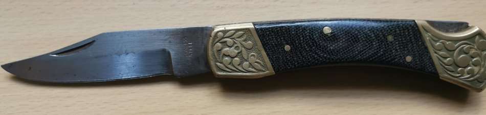 Large vintage stainless steel lock knife with snakeskin pattern handle