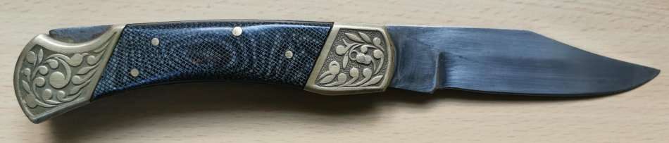 Large vintage stainless steel lock knife with snakeskin pattern handle